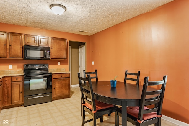 3872 Dusty Sands Rd, Whitestown, IN 46075 - kitchen featuring black appliances, brown cabinetry, light flooring, light countertops, and a textured ceiling