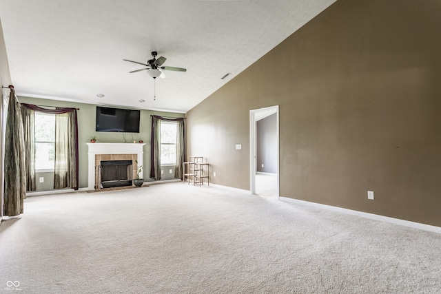 3872 Dusty Sands Rd, Whitestown, IN 46075 - unfurnished living room featuring a ceiling fan, a tile fireplace, carpet flooring, and high vaulted ceiling