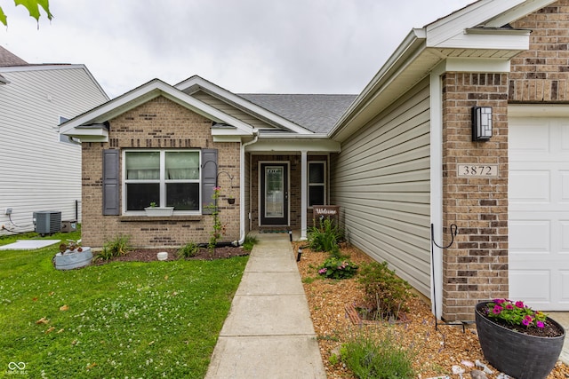 3872 Dusty Sands Rd, Whitestown, IN 46075 - view of exterior entry featuring a garage, brick siding, and a yard