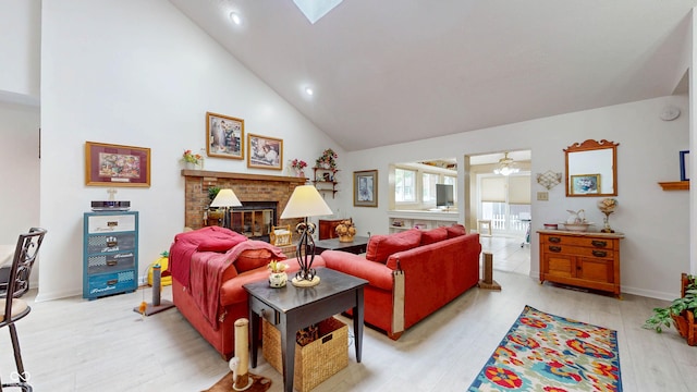 1067 Acadia Ct, Indianapolis, IN 46217 - living room with light wood finished floors, a brick fireplace, high vaulted ceiling, ceiling fan, and recessed lighting