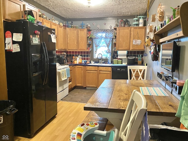 403 N College Ave, Greencastle, IN 46135 - kitchen with black appliances, open shelves, light wood finished floors, and a textured ceiling