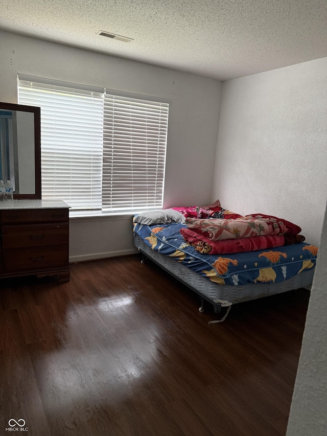 8113 Maple Stream Ln, Indianapolis, IN 46217 - bedroom featuring wood finished floors and a textured ceiling