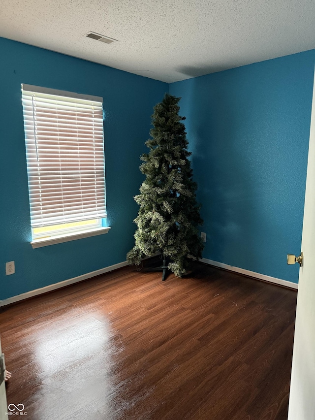 8113 Maple Stream Ln, Indianapolis, IN 46217 - spare room with wood finished floors and a textured ceiling