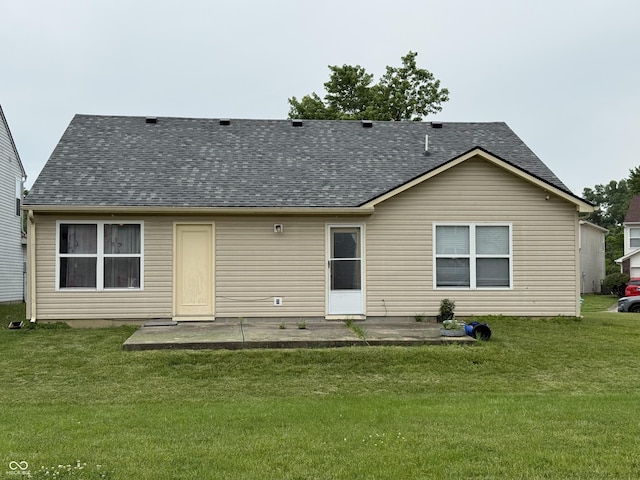 8113 Maple Stream Ln, Indianapolis, IN 46217 - rear view of property with a shingled roof, a patio, and a lawn