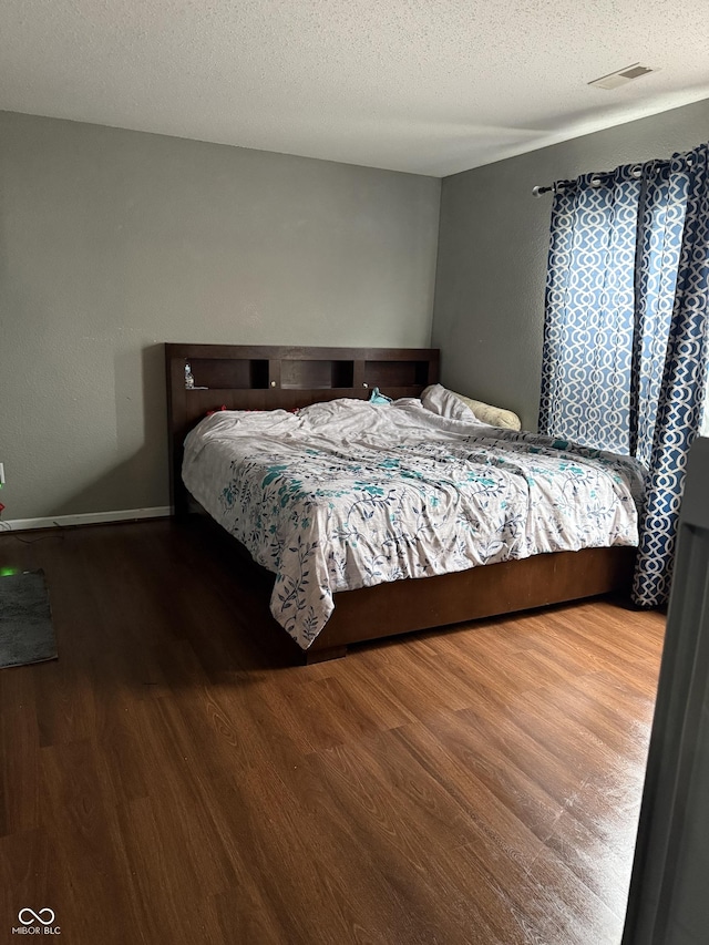 8113 Maple Stream Ln, Indianapolis, IN 46217 - bedroom with wood finished floors and a textured ceiling