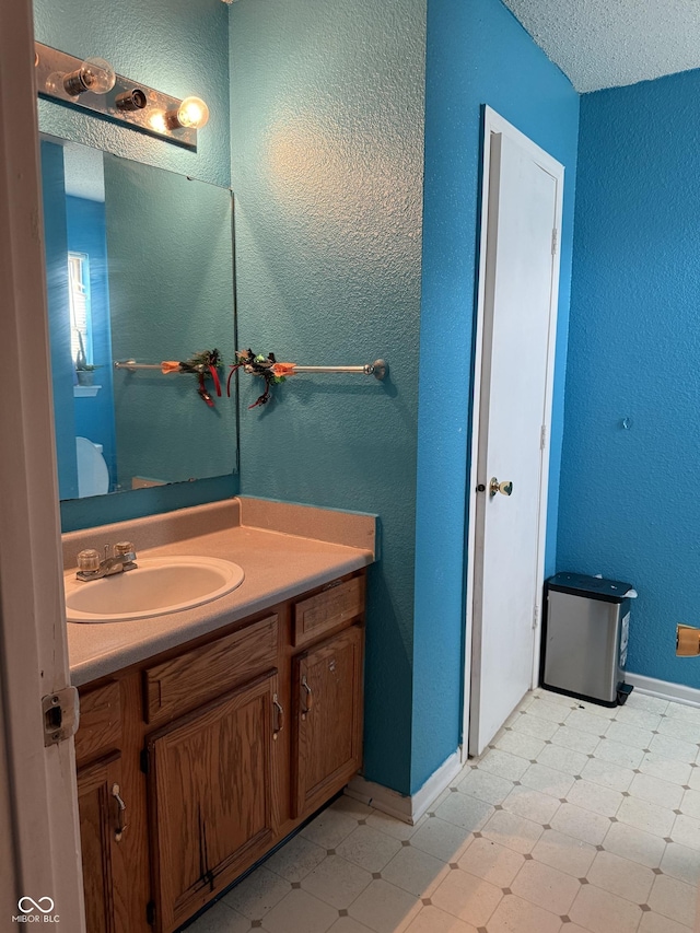 8113 Maple Stream Ln, Indianapolis, IN 46217 - bathroom featuring vanity, tile patterned floors, and a textured wall
