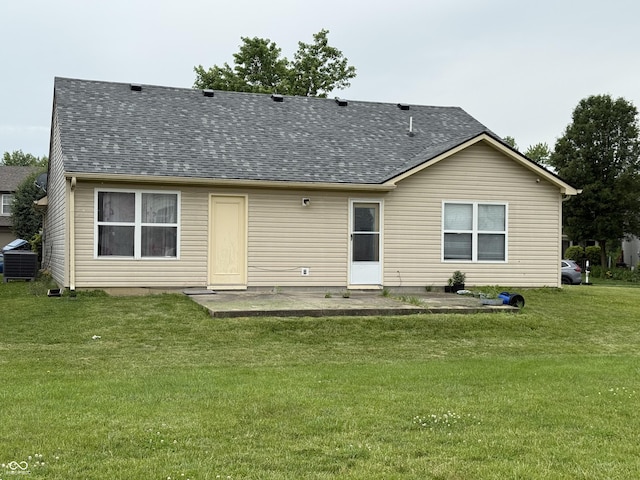 8113 Maple Stream Ln, Indianapolis, IN 46217 - rear view of house featuring roof with shingles, a yard, and a patio area