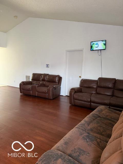 8113 Maple Stream Ln, Indianapolis, IN 46217 - living room with lofted ceiling and wood finished floors