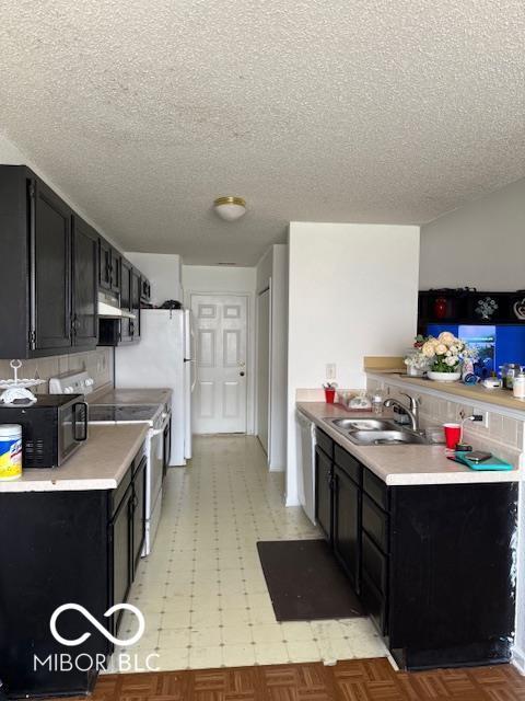 8113 Maple Stream Ln, Indianapolis, IN 46217 - kitchen with electric stove, extractor fan, dark cabinetry, a textured ceiling, and light countertops