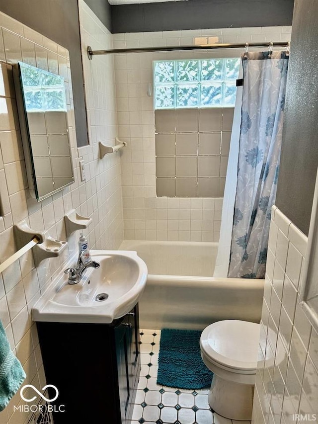 313 S Brittain Ave, Muncie, IN 47303 - bathroom with tile walls, shower / tub combo, vanity, and healthy amount of natural light