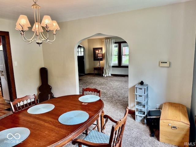 313 S Brittain Ave, Muncie, IN 47303 - dining space featuring arched walkways, a chandelier, and carpet floors