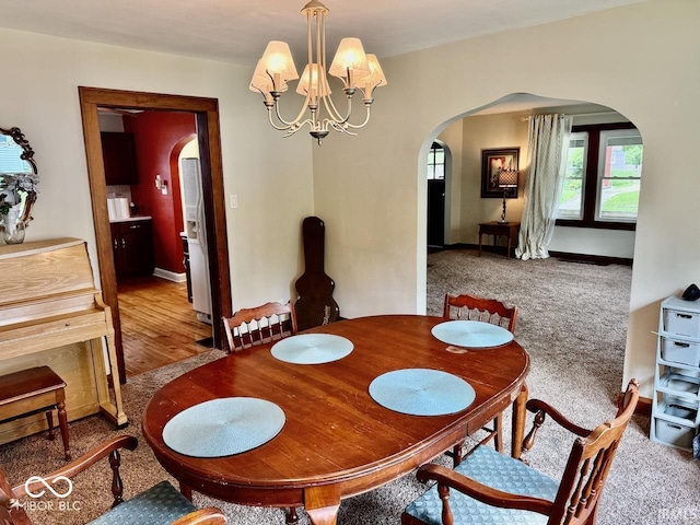 313 S Brittain Ave, Muncie, IN 47303 - dining room with arched walkways, a chandelier, and carpet flooring