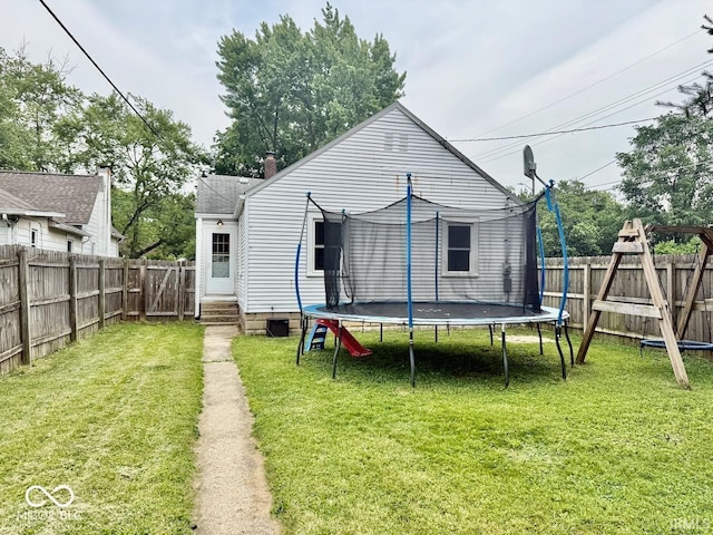 313 S Brittain Ave, Muncie, IN 47303 - back of property with a trampoline and a fenced backyard