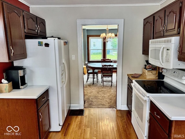 313 S Brittain Ave, Muncie, IN 47303 - kitchen with white appliances, a chandelier, crown molding, light wood-style floors, and light countertops