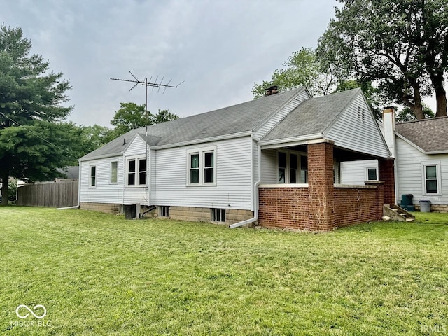 313 S Brittain Ave, Muncie, IN 47303 - rear view of house with a shingled roof and a chimney