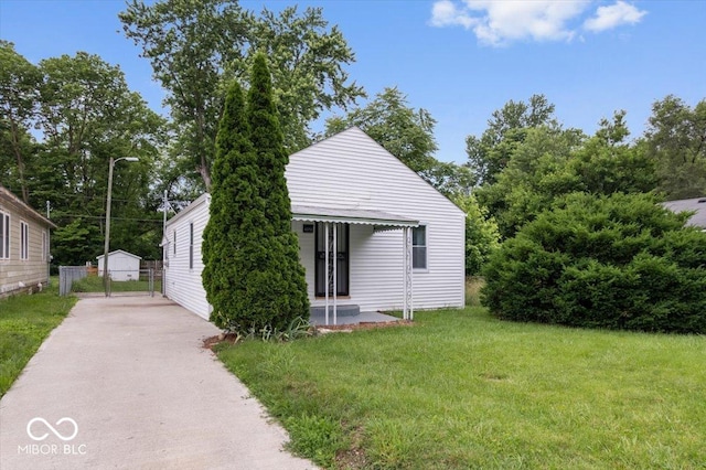 4310 Crittenden Ave, Indianapolis, IN 46205 - view of front of house featuring a front lawn, a gate, and concrete driveway