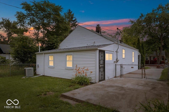4310 Crittenden Ave, Indianapolis, IN 46205 - property exterior at dusk featuring a gate and a chimney
