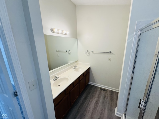 5938 Tybalt Ln, Indianapolis, IN 46254 - bathroom with double vanity, wood finished floors, and a shower with shower door