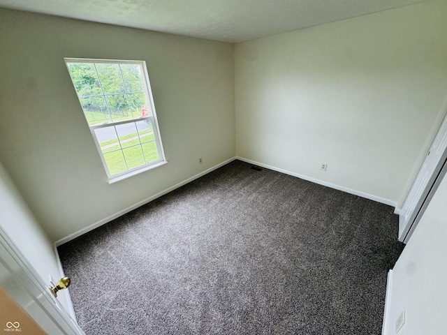 5938 Tybalt Ln, Indianapolis, IN 46254 - spare room with dark colored carpet and baseboards
