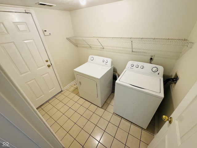 5938 Tybalt Ln, Indianapolis, IN 46254 - laundry room with separate washer and dryer and light tile patterned floors