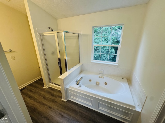 5938 Tybalt Ln, Indianapolis, IN 46254 - bathroom featuring a whirlpool tub, a stall shower, wood finished floors, and a textured ceiling