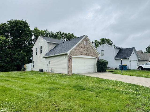 5938 Tybalt Ln, Indianapolis, IN 46254 - view of side of home featuring an attached garage, a yard, brick siding, and driveway