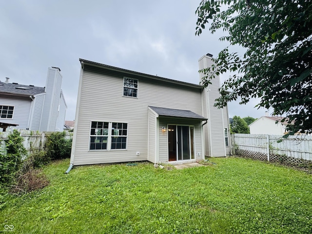 5938 Tybalt Ln, Indianapolis, IN 46254 - back of property with a fenced backyard and a chimney