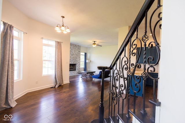 7493 W Lane Rd, Mccordsville, IN 46055 - entrance foyer with a fireplace, dark wood finished floors, stairway, ceiling fan, and a chandelier