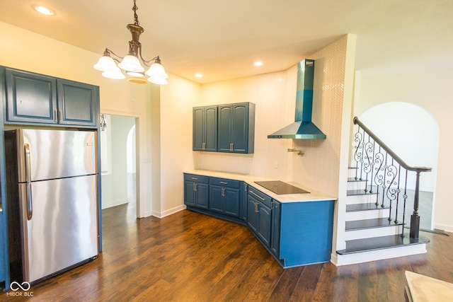 7493 W Lane Rd, Mccordsville, IN 46055 - kitchen with freestanding refrigerator, wall chimney exhaust hood, blue cabinetry, black electric cooktop, and dark wood-type flooring