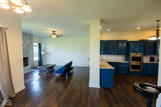7493 W Lane Rd, Mccordsville, IN 46055 - kitchen featuring dark wood-style flooring, blue cabinets, light countertops, double oven, and recessed lighting