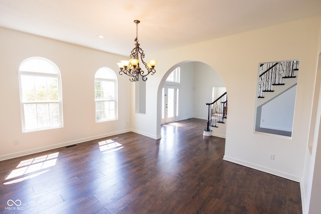 7493 W Lane Rd, Mccordsville, IN 46055 - empty room featuring arched walkways, stairway, a chandelier, dark wood-style floors, and recessed lighting