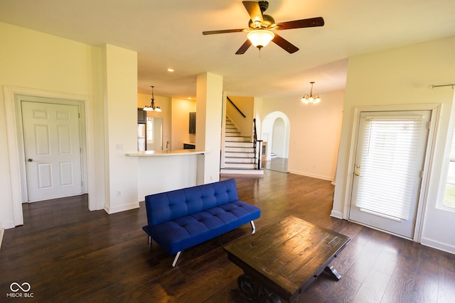 7493 W Lane Rd, Mccordsville, IN 46055 - sitting room with a chandelier, arched walkways, stairs, dark wood finished floors, and a ceiling fan