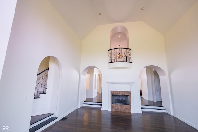 7493 W Lane Rd, Mccordsville, IN 46055 - unfurnished living room featuring wood finished floors, high vaulted ceiling, and a tile fireplace