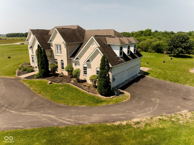 7493 W Lane Rd, Mccordsville, IN 46055 - view of front of property featuring asphalt driveway, a garage, and a front lawn