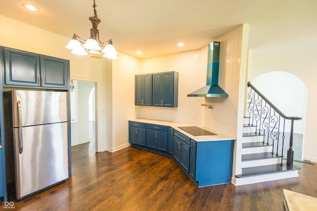 7493 W Lane Rd, Mccordsville, IN 46055 - kitchen featuring freestanding refrigerator, wall chimney range hood, blue cabinets, black electric cooktop, and dark wood finished floors