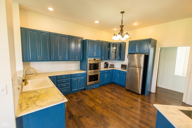 7493 W Lane Rd, Mccordsville, IN 46055 - kitchen with appliances with stainless steel finishes, a chandelier, light countertops, hanging light fixtures, and blue cabinetry