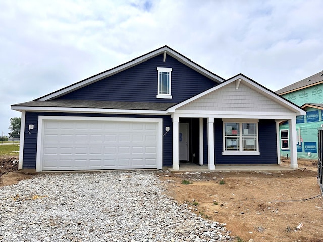 1175 Mcbride St, Greenfield, IN 46140 - view of front of property with a porch, gravel driveway, and an attached garage