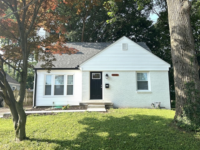 2631 Mcleay Dr, Indianapolis, IN 46220 - bungalow-style home featuring a front lawn, brick siding, and roof with shingles
