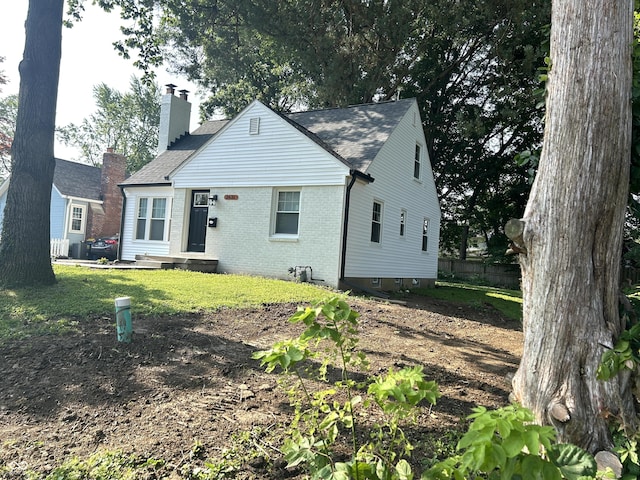 2631 Mcleay Dr, Indianapolis, IN 46220 - view of front of home featuring brick siding and a chimney