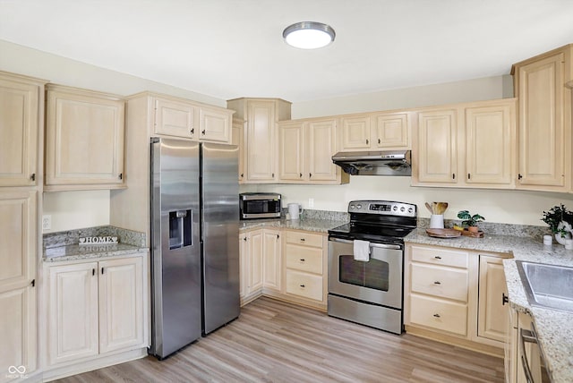 6050 Acorn Dr, Columbus, IN 47201 - kitchen with stainless steel appliances, extractor fan, light wood-style floors, and light stone countertops