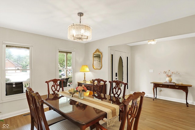 6050 Acorn Dr, Columbus, IN 47201 - dining area featuring a chandelier and light wood-type flooring
