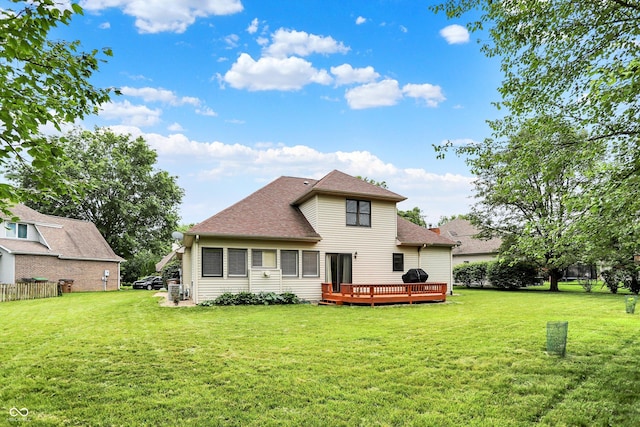 6050 Acorn Dr, Columbus, IN 47201 - back of property with a deck, a lawn, and a shingled roof