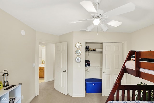 6050 Acorn Dr, Columbus, IN 47201 - bedroom with light colored carpet, a closet, and ceiling fan