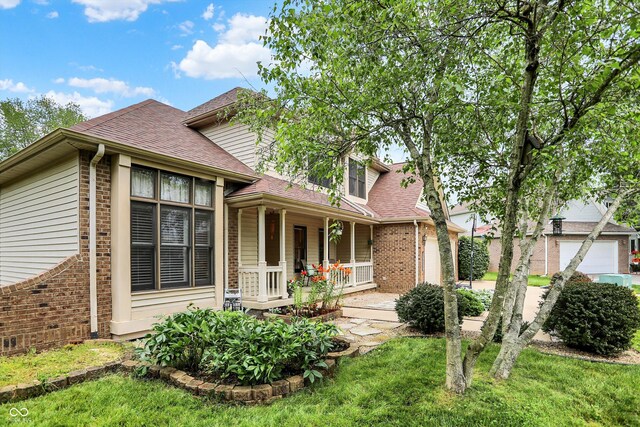 6050 Acorn Dr, Columbus, IN 47201 - rear view of house featuring brick siding, a porch, and roof with shingles