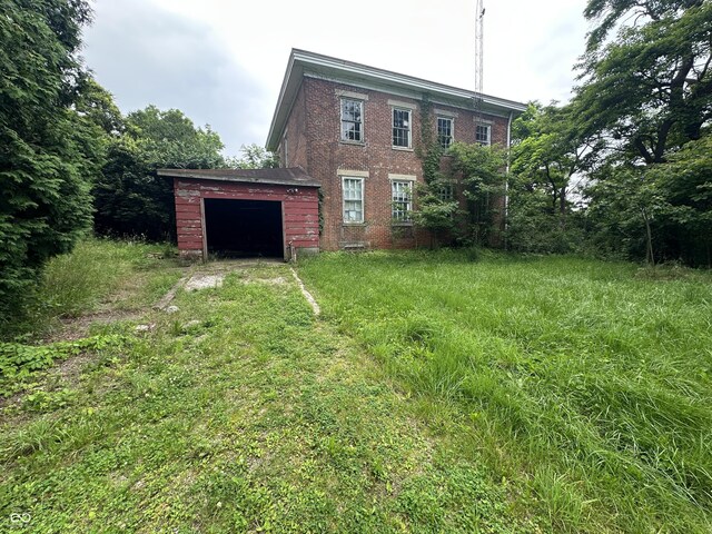 6100 Hodgin Rd, Richmond, IN 47374 - back of property with an attached garage and brick siding