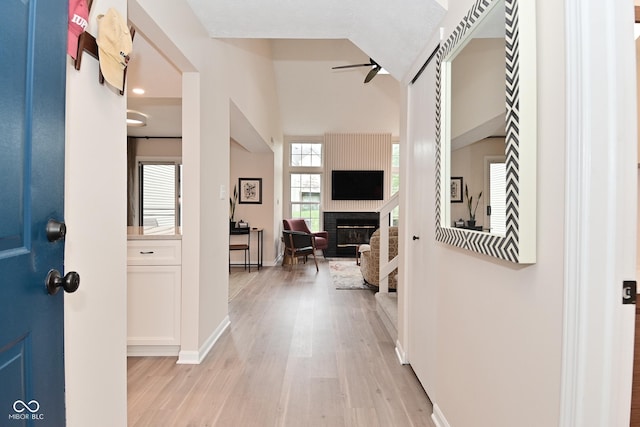 9477 Aberdare Dr N, Indianapolis, IN 46250 - entrance foyer featuring a large fireplace, ceiling fan, and light wood-type flooring