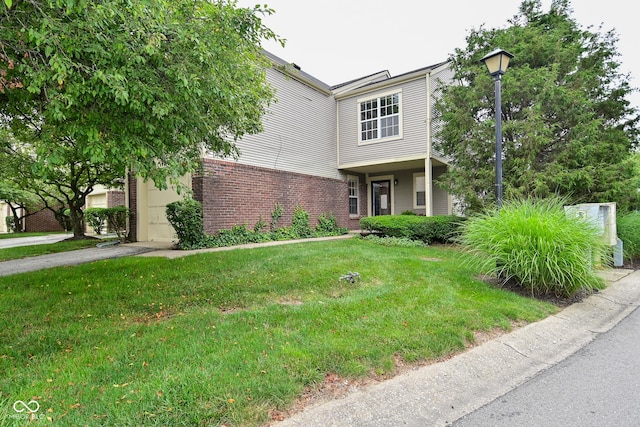 9477 Aberdare Dr N, Indianapolis, IN 46250 - view of front of house featuring brick siding, a front lawn, and asphalt driveway