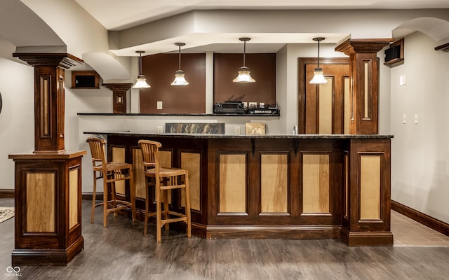 7743 Camelback Dr, Indianapolis, IN 46250 - community bar area featuring decorative columns, dark wood-style flooring, and hanging light fixtures