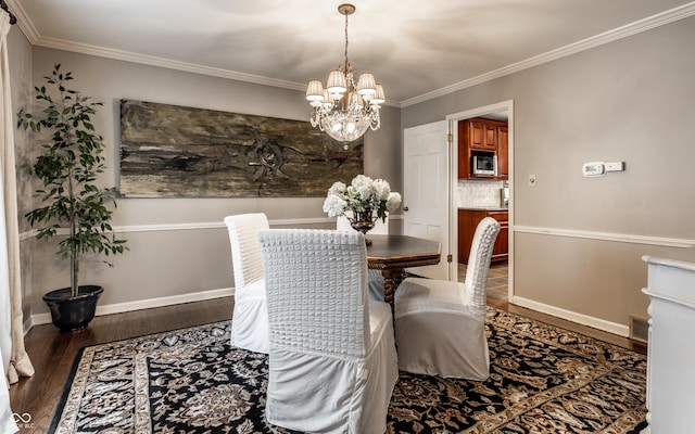 7743 Camelback Dr, Indianapolis, IN 46250 - dining area with wood finished floors, a chandelier, and ornamental molding