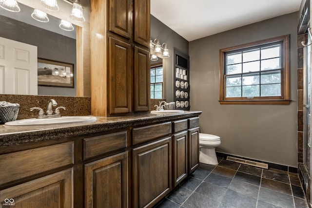 7743 Camelback Dr, Indianapolis, IN 46250 - full bathroom with double vanity, healthy amount of natural light, and stone finish flooring